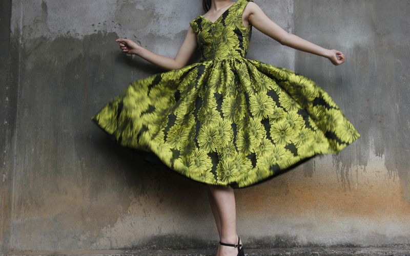Woman in a floral midi dress with heels for evening wear